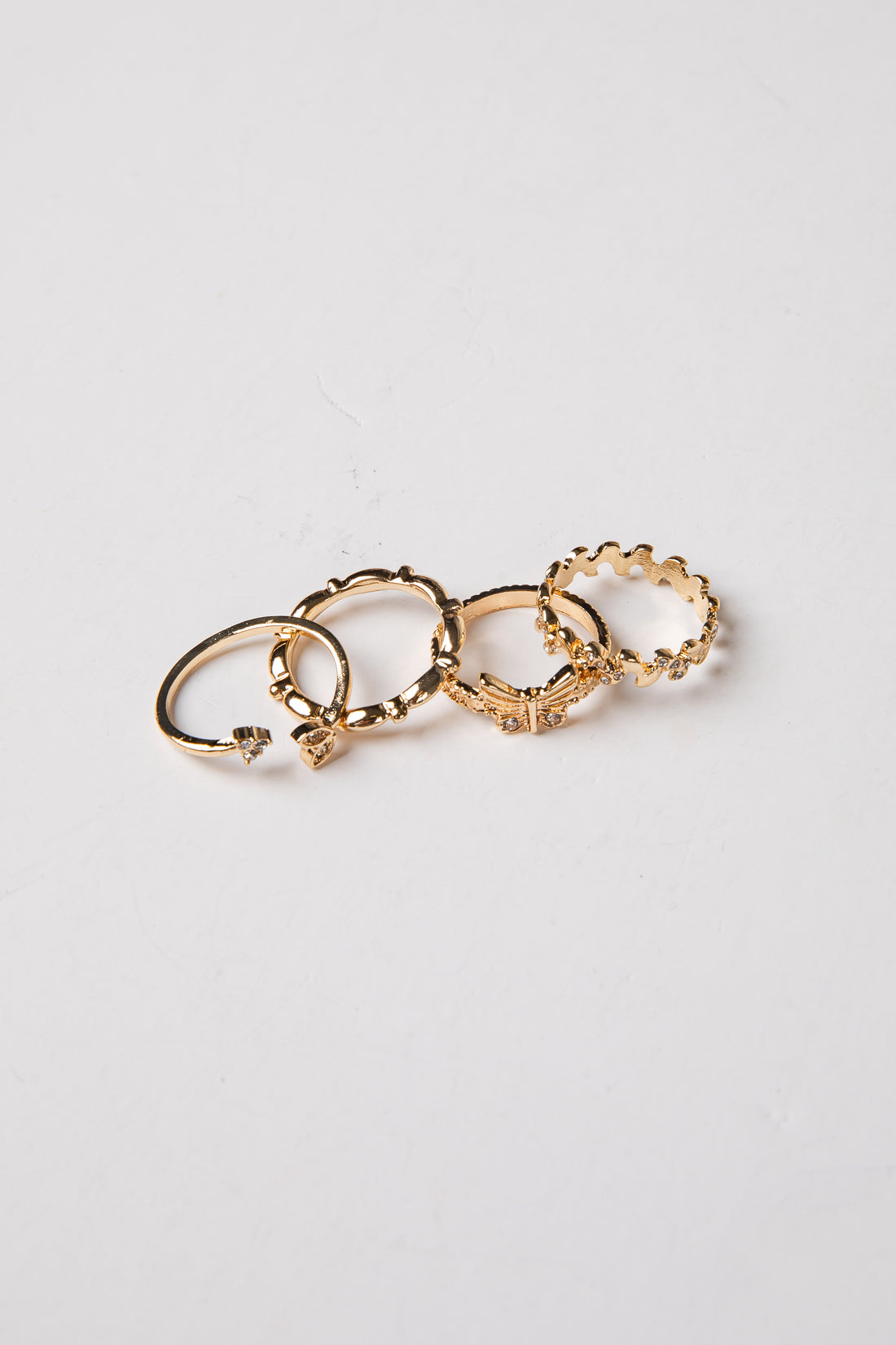Set of gold hoop earrings on a light gray background