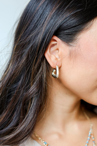 Gold Textured Triangle Earrings on model