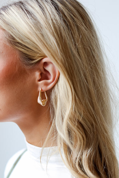 Gold Abstract Hoop Earrings on model