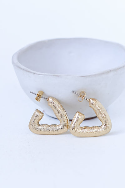 Gold Textured Triangle Earrings flat lay
