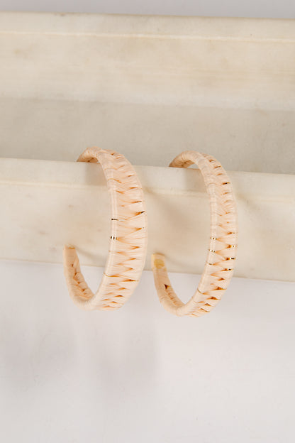 Pair of gold hoop earrings on a white surface