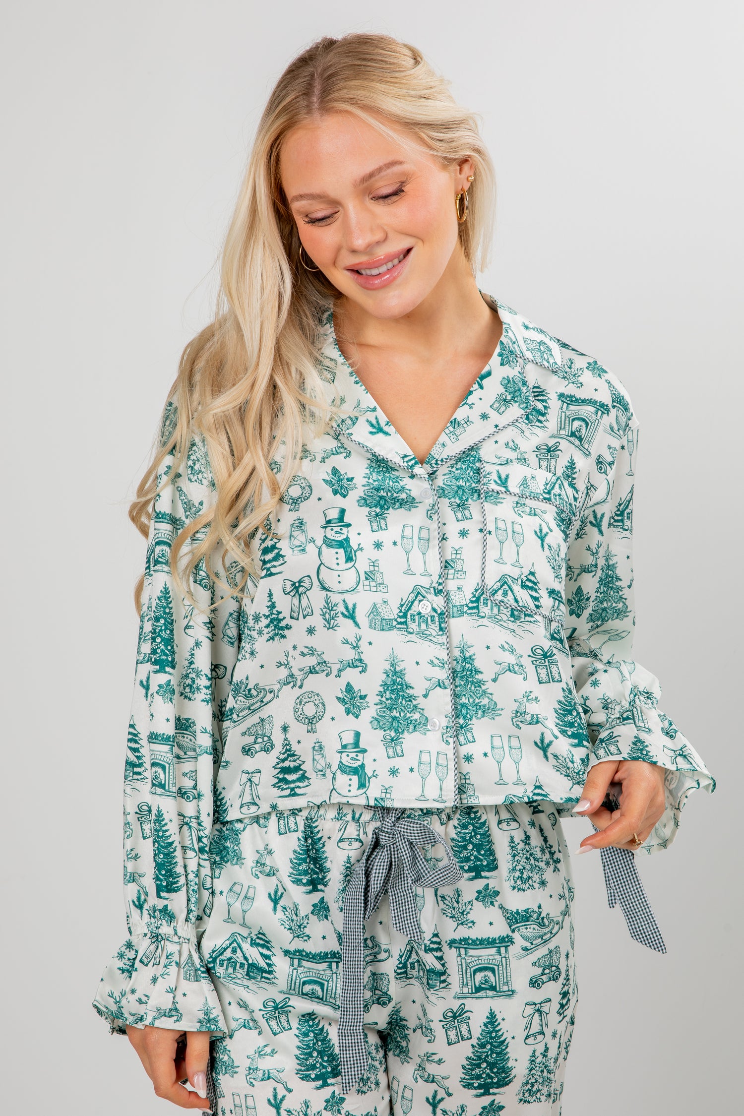 Woman wearing a festive pajama set with a white background