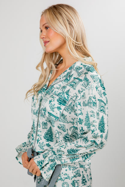 Woman wearing a teal and white patterned outfit on a plain background