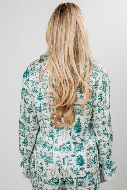 Person wearing a patterned shirt with long blonde hair, on a plain background