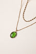 Necklace with a green pendant on a light background