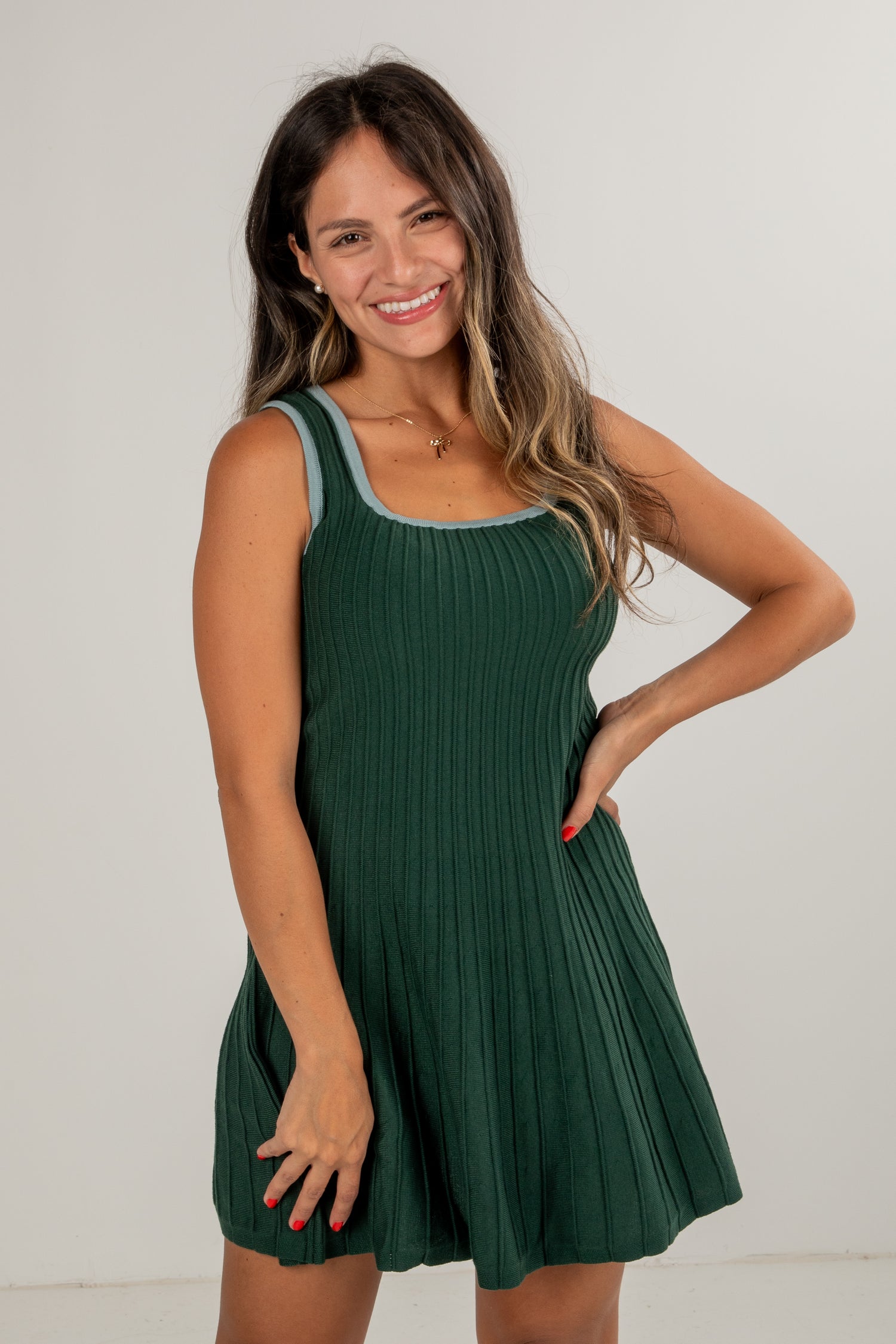 Woman wearing a green dress against a white background