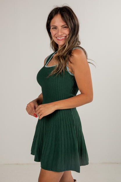 Woman wearing a green dress against a white background
