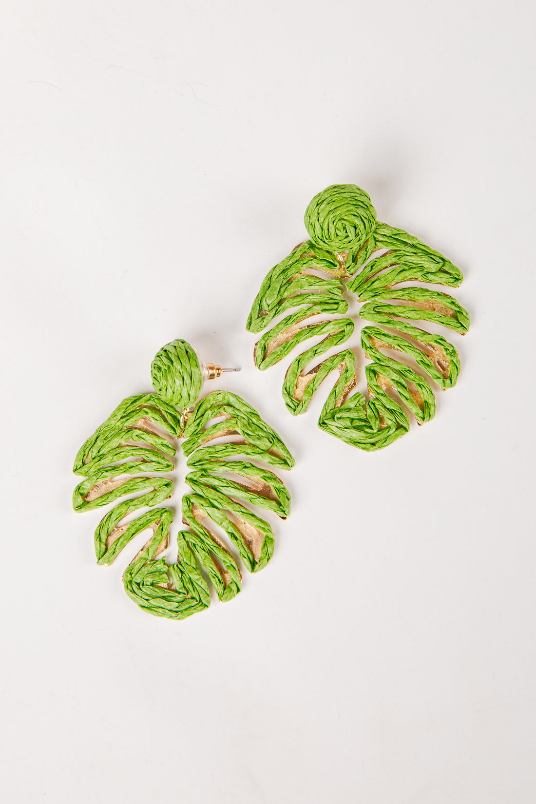 Green leaf-shaped earrings on a white background