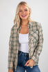 Woman wearing a plaid shirt over a white top and jeans on a white background