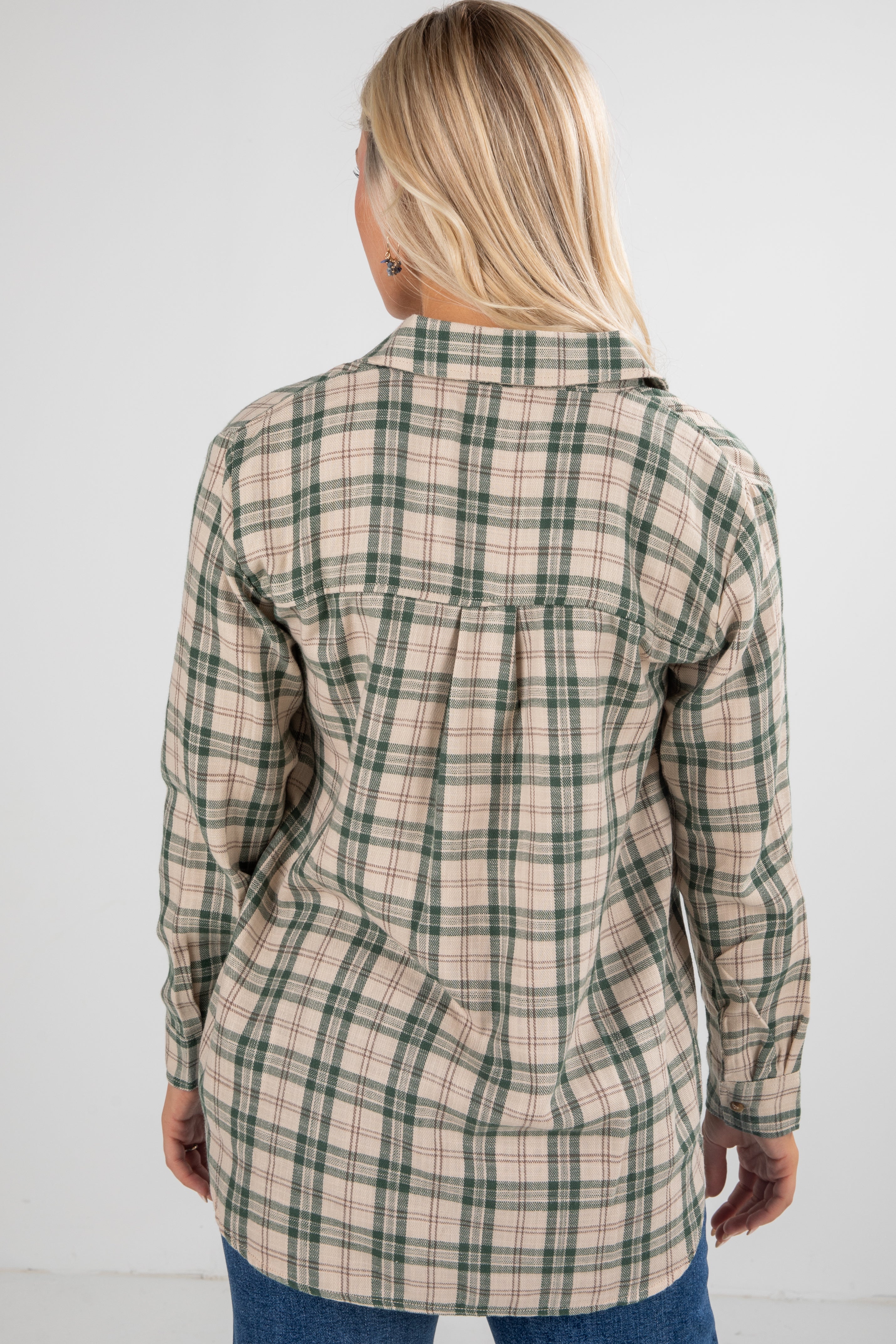 Woman wearing a plaid shirt against a white background