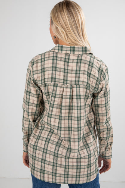 Woman wearing a plaid shirt against a white background