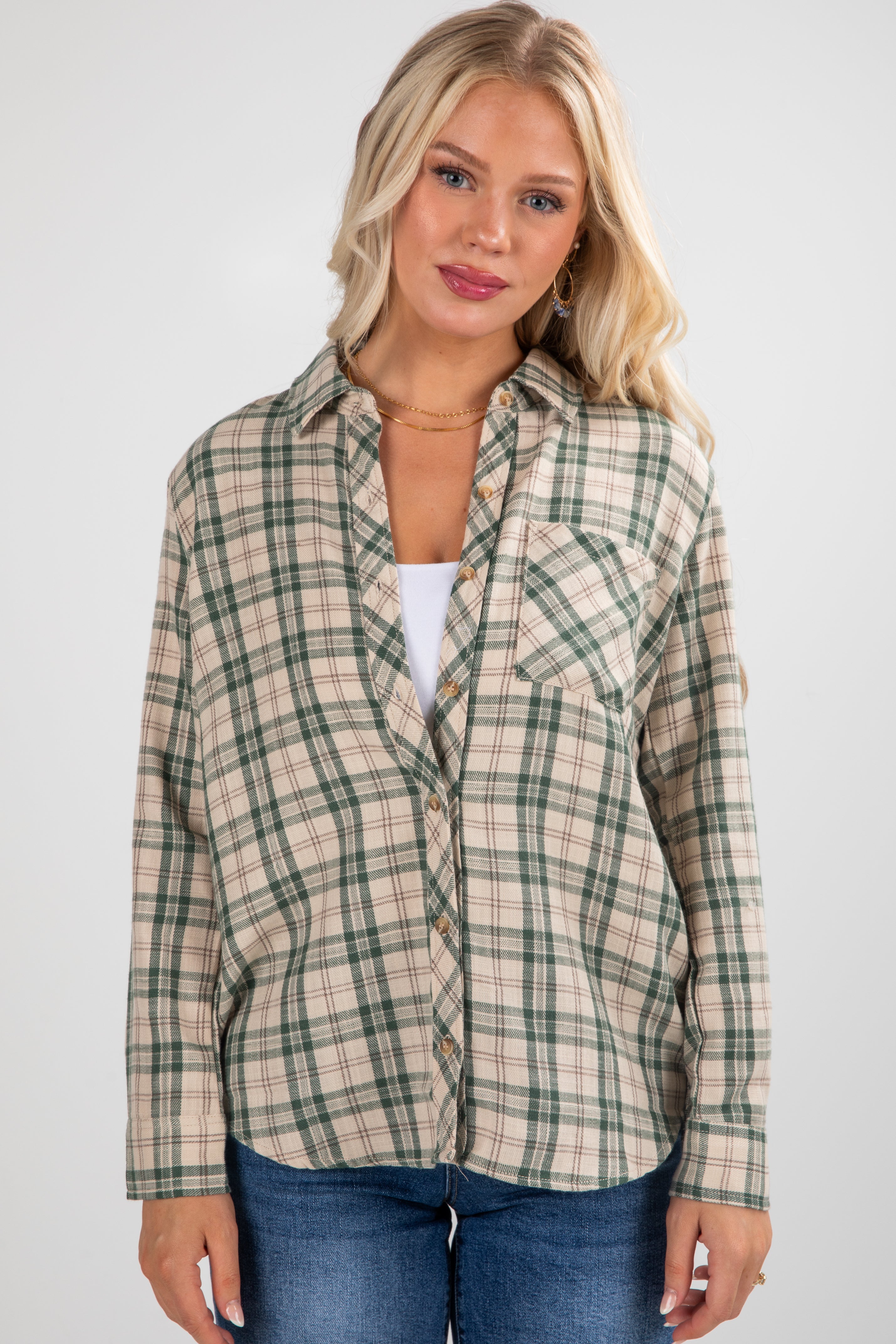 Woman wearing a plaid shirt and jeans on a white background