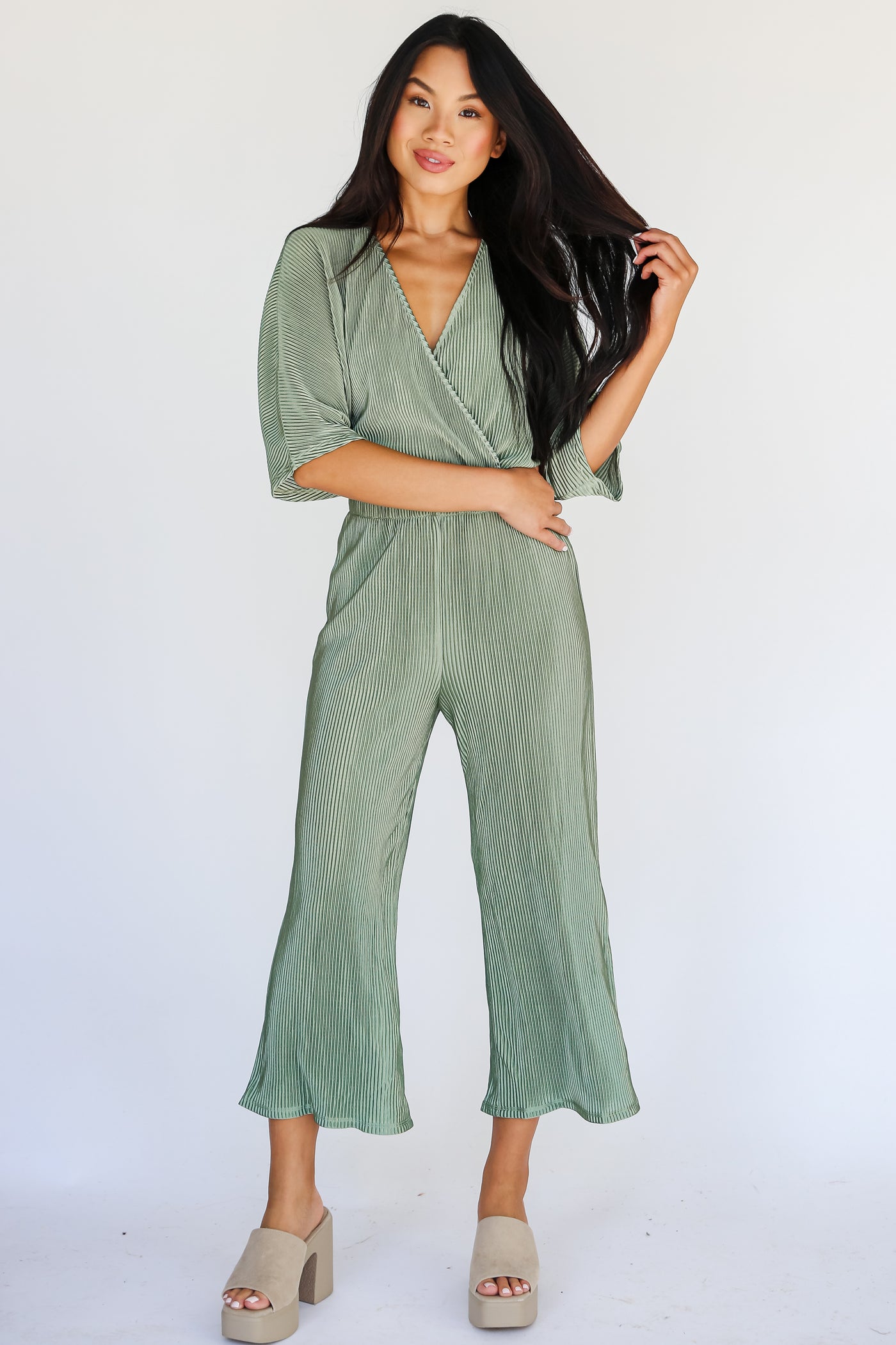 model wearing a Plisse Green Jumpsuit