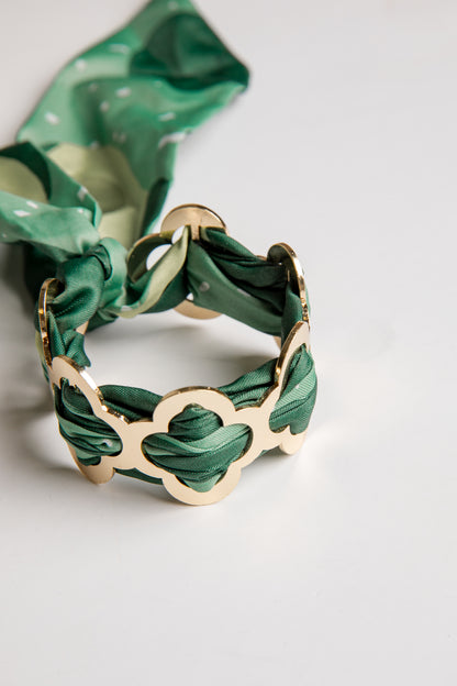 Green woven bracelet on a white background