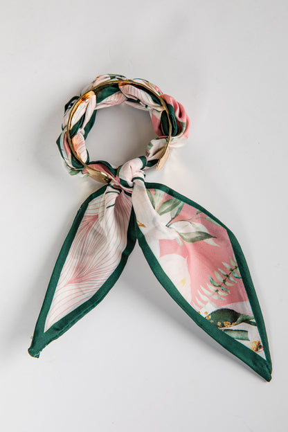 Floral headband with green accents on a light gray background