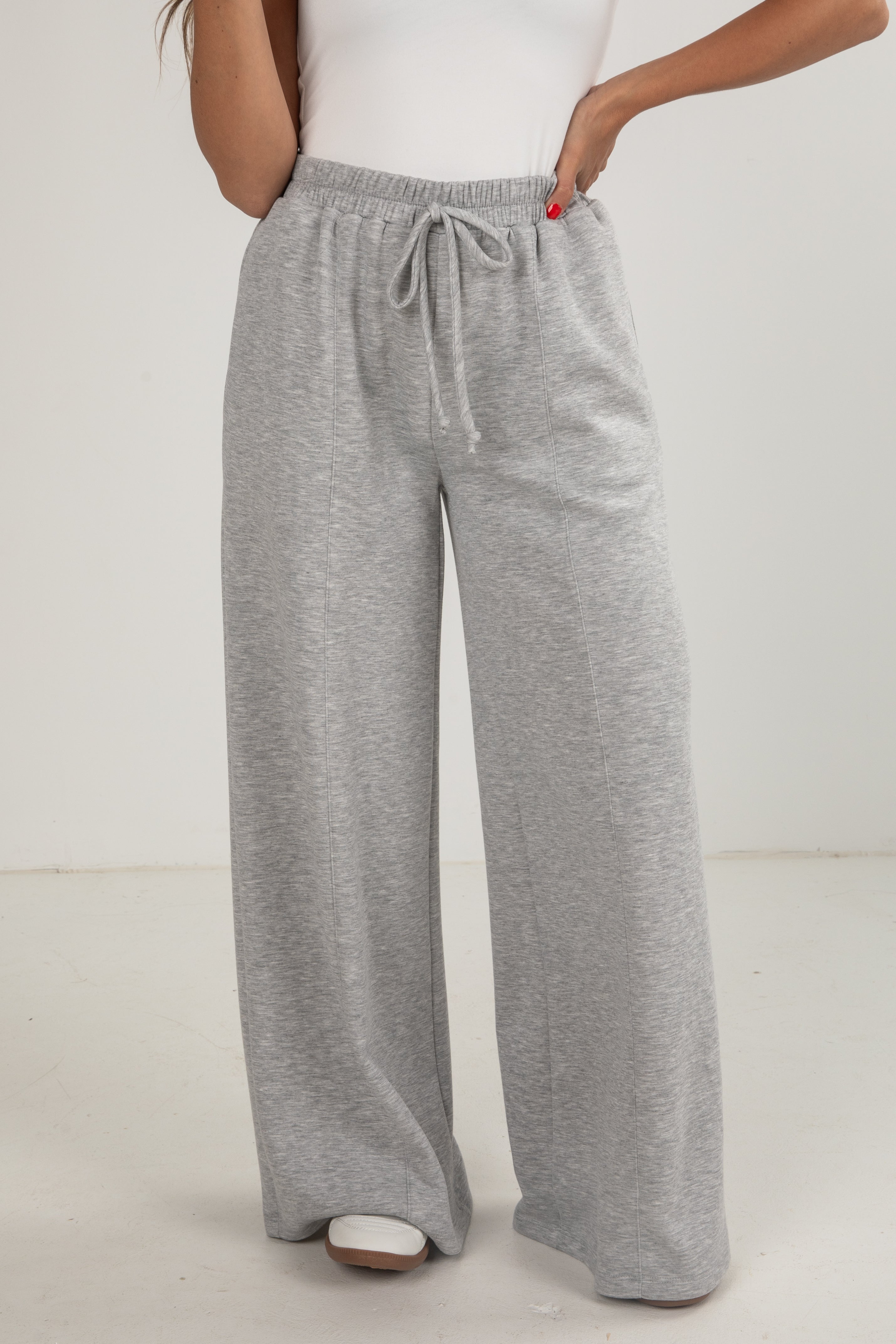 Gray wide-leg pants worn by a person on a white background