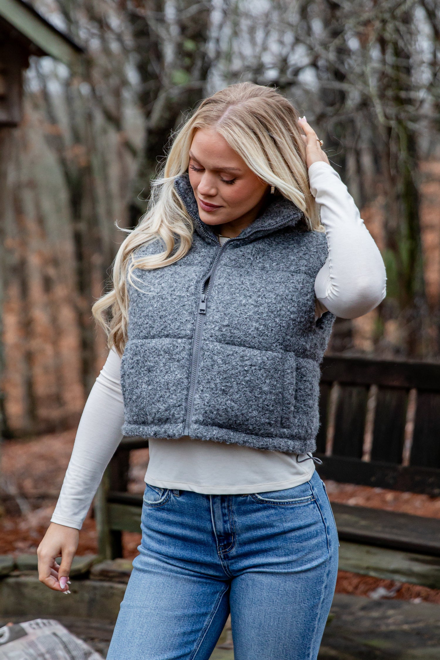 Woman wearing a gray puffer vest outdoors