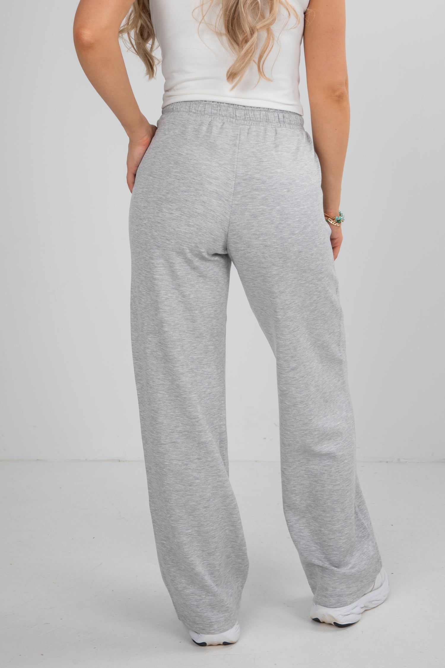 Person wearing gray sweatpants on a white background