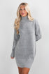 Woman wearing a gray sweater dress against a white background