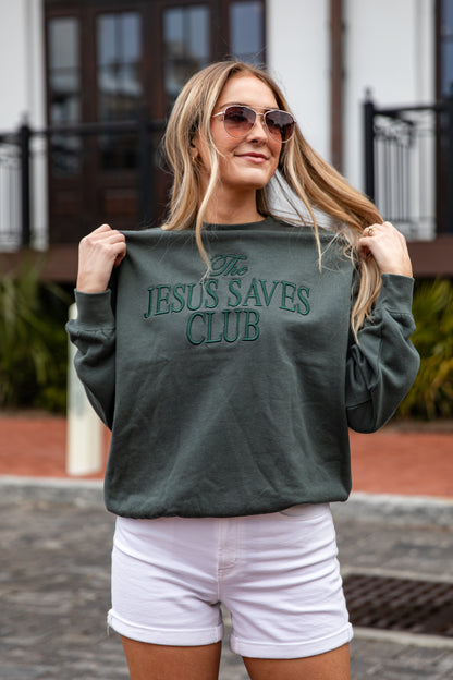 Woman wearing a green sweatshirt with &