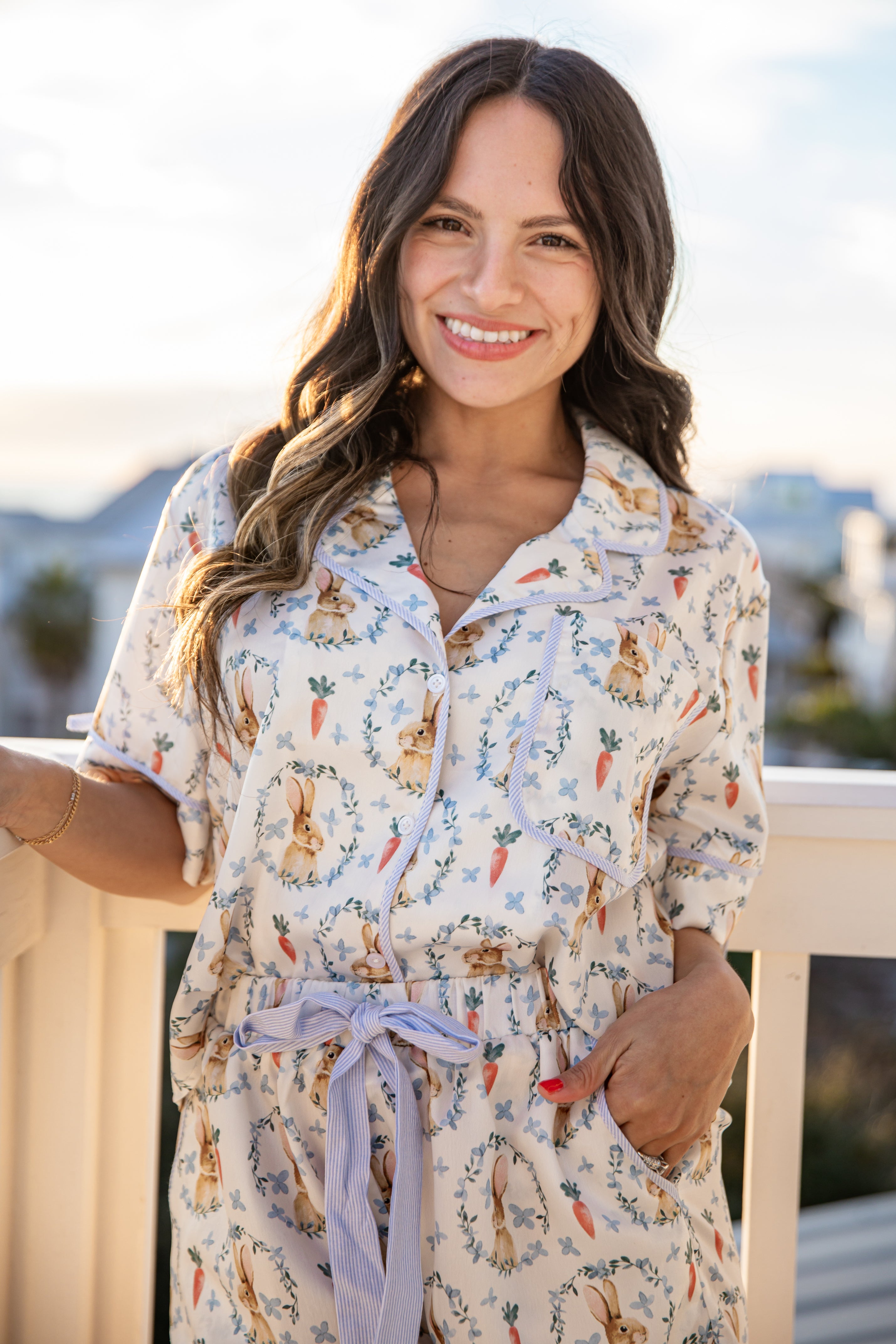 Woman wearing a patterned dress with a scenic background