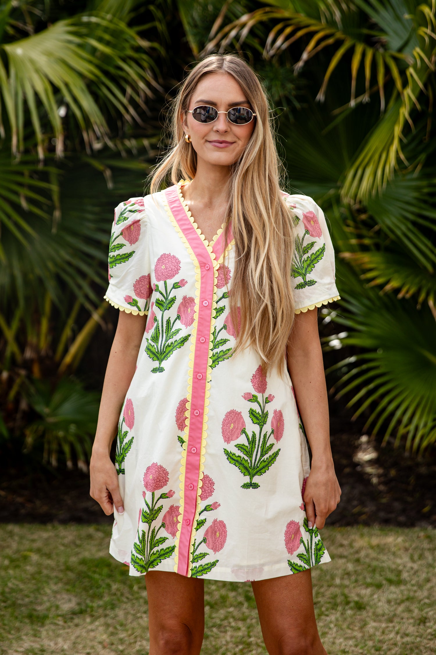 Woman wearing a floral dress with a tropical background