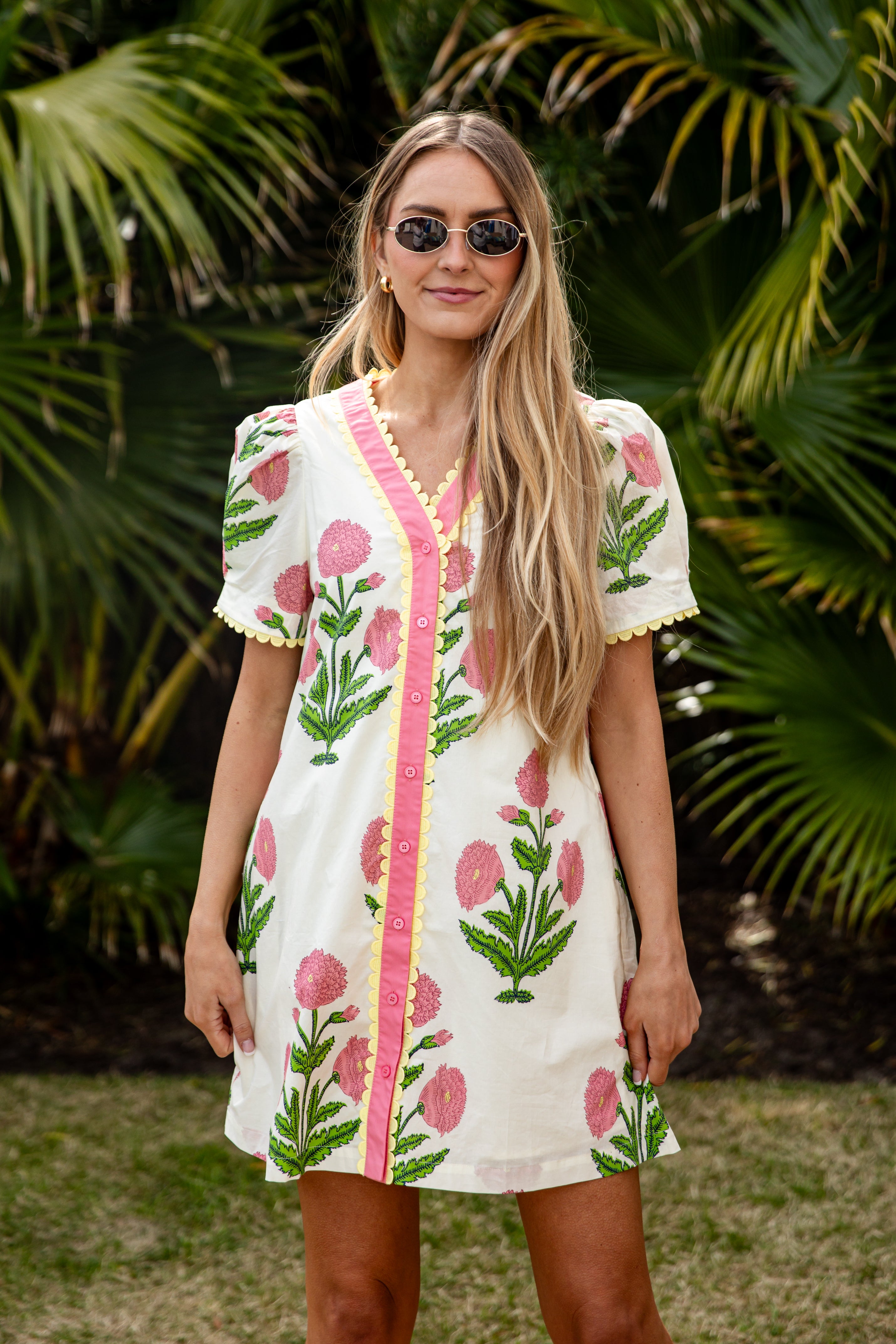 Woman wearing a floral dress with a tropical background