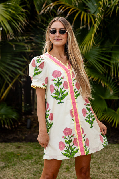 Woman wearing a floral dress with a tropical background