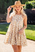 Woman wearing a floral dress and hat outdoors