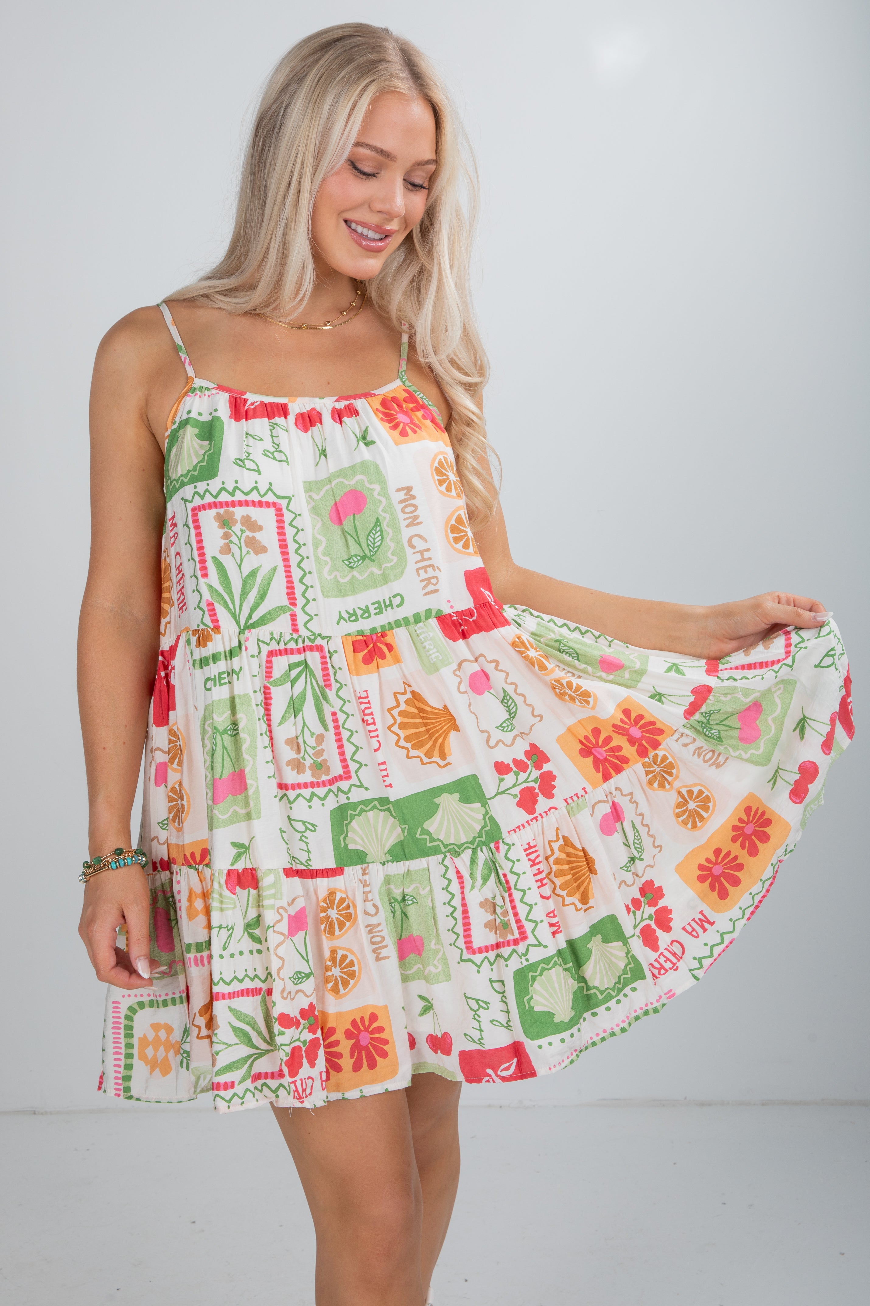 Woman wearing a colorful patterned dress against a white background