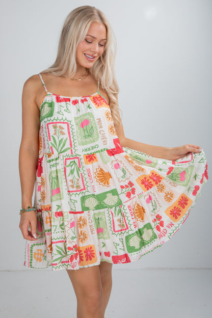 Woman wearing a colorful patterned dress against a white background