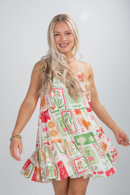 Woman wearing a colorful patterned dress on a plain background