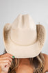 Beige cowboy hat with braided detail on a plain background
