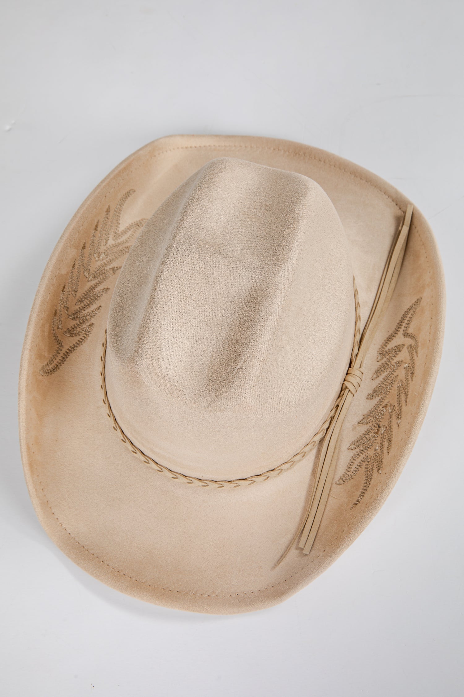 Beige cowboy hat with embroidery on a light gray background
