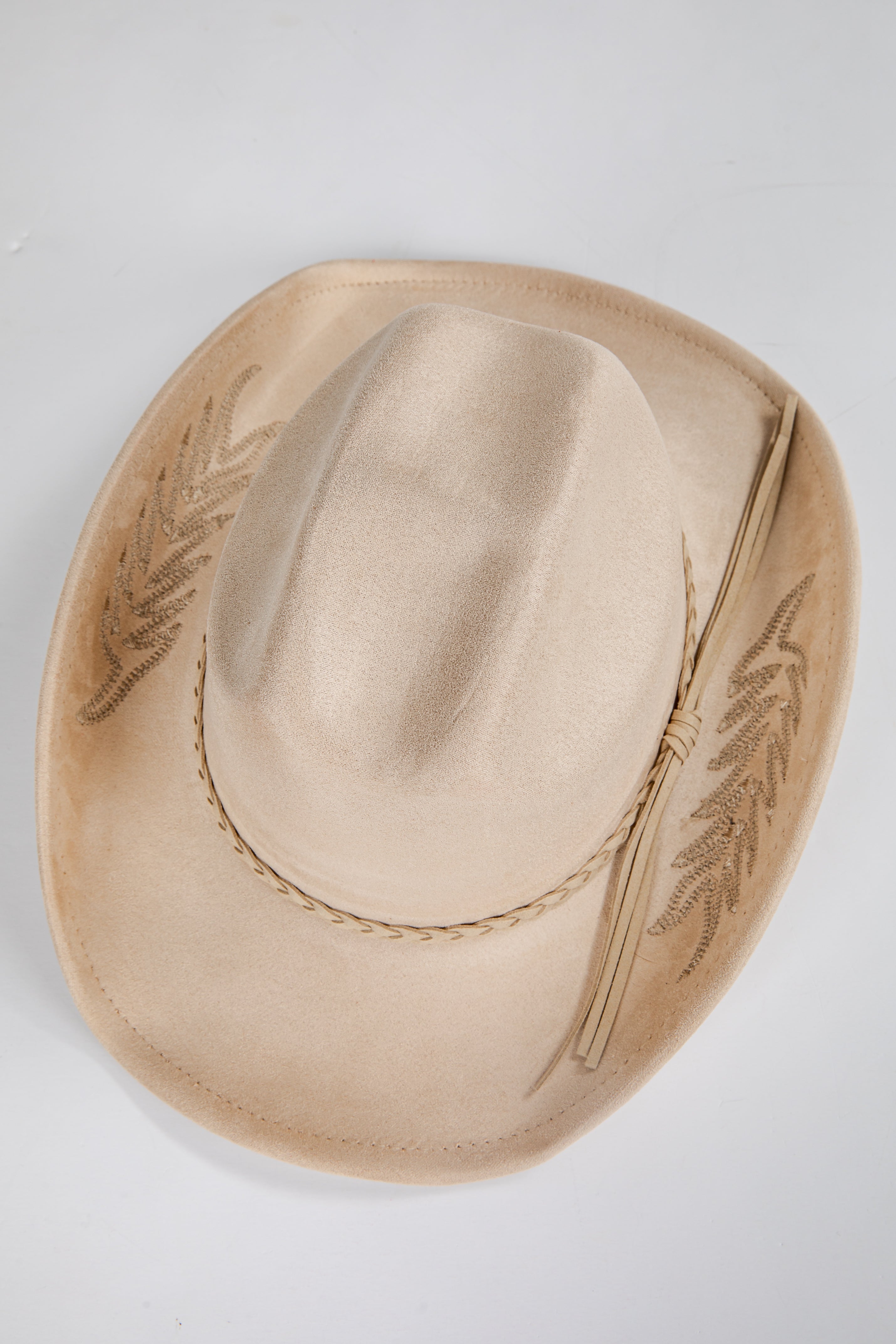 Beige cowboy hat with embroidery on a light gray background