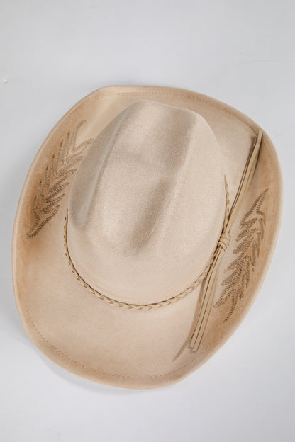 Beige cowboy hat with embroidery on a light gray background