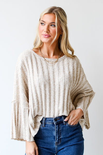 model wearing a taupe Sweater