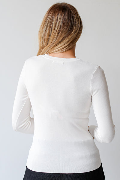white long sleeve knit top