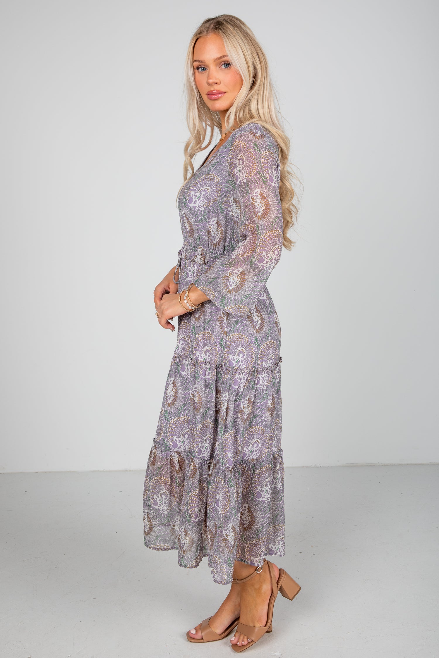 Woman wearing a floral dress with a plain background