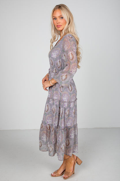 Woman wearing a floral dress with a plain background