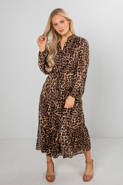 Woman wearing a leopard print dress against a white background