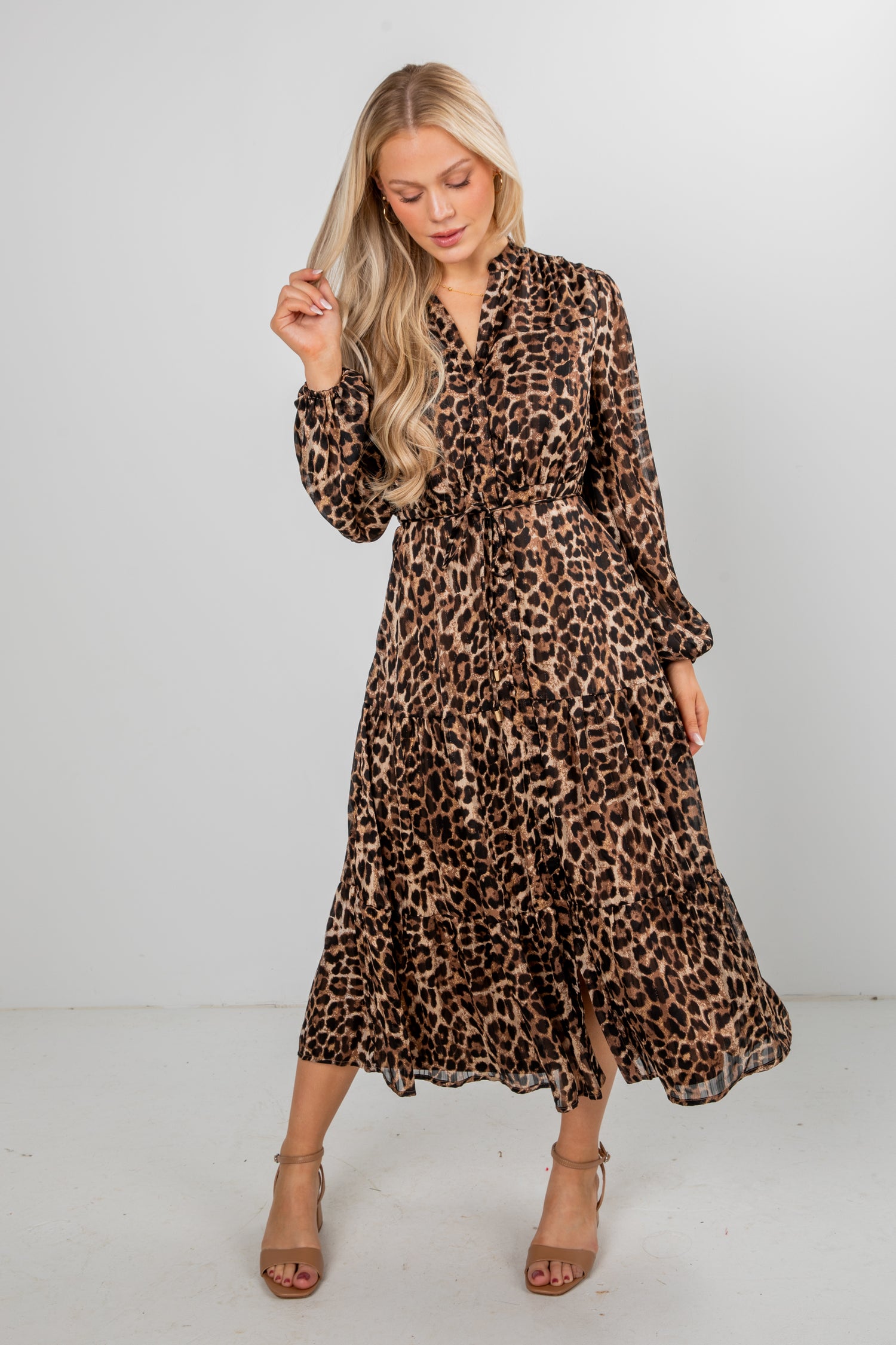 Woman wearing a leopard print dress against a white background