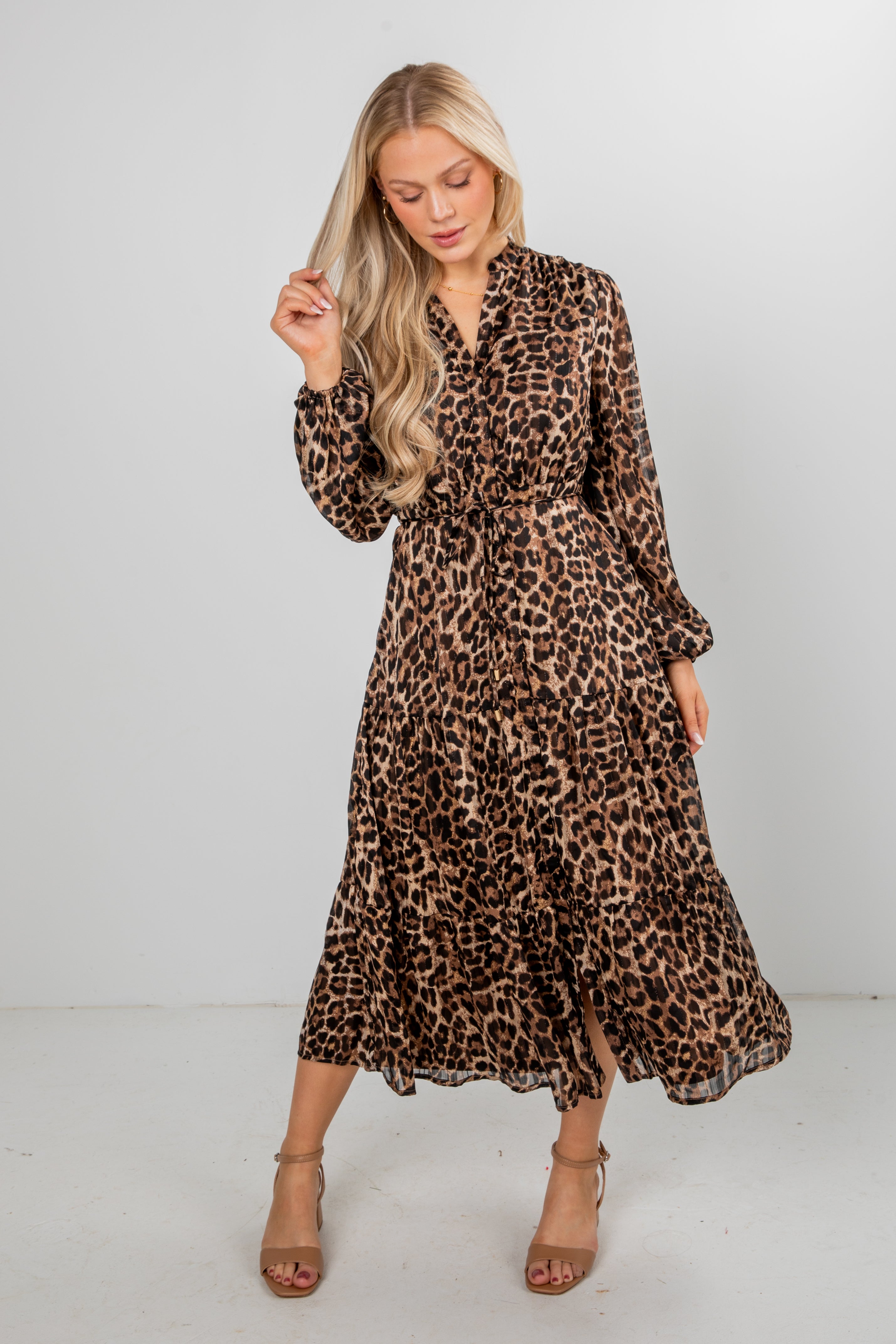 Woman wearing a leopard print dress against a white background
