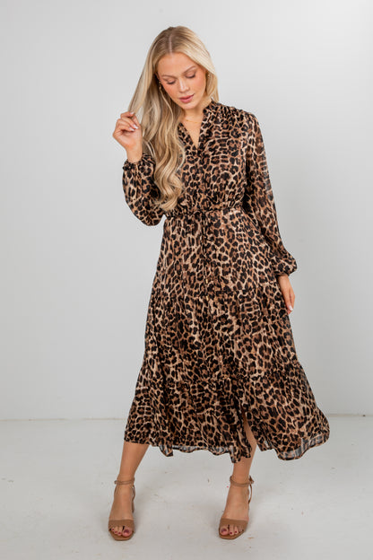 Woman wearing a leopard print dress against a white background
