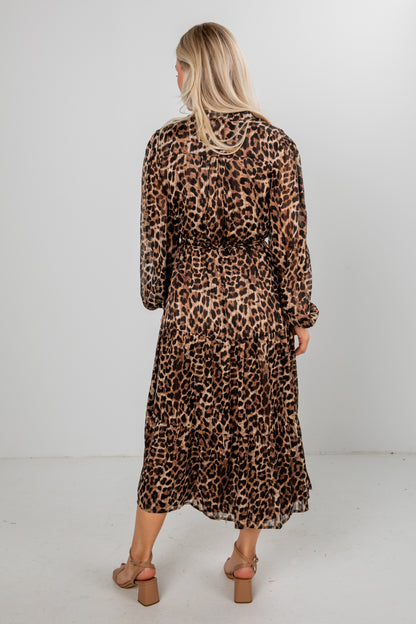 Woman wearing a leopard print dress on a white background