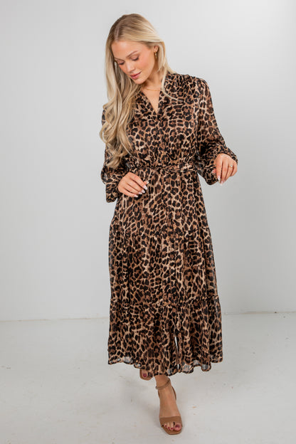 Woman wearing a leopard print dress on a white background