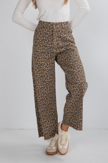 Person wearing leopard print pants on a white background