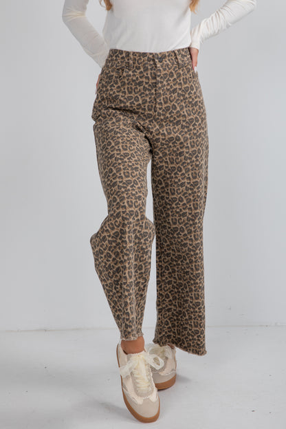 Leopard print pants worn by a person on a white background