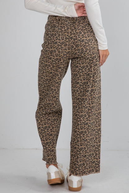 Leopard print pants worn by a person on a plain background