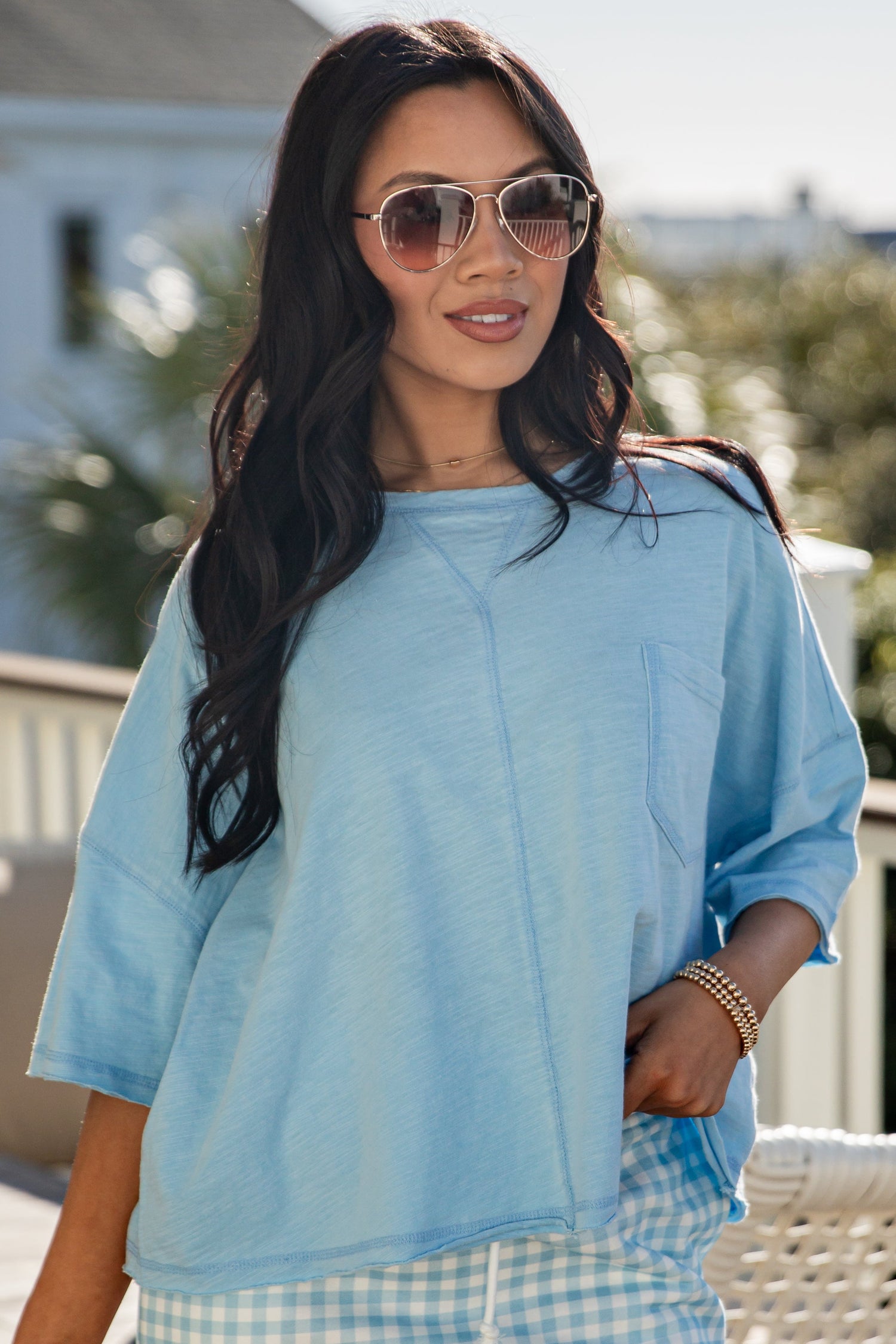 woman wearing a blue casual basic top with front pocket
